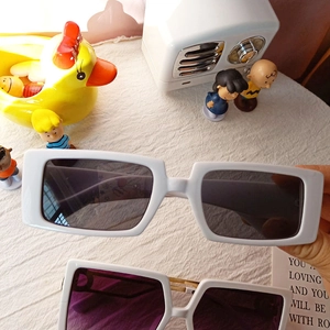 Retro white rectangular sunglasses with dark lenses for a trendy street fashion look