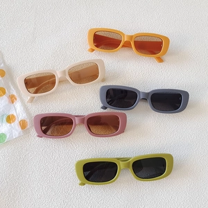 Retro rectangular sunglasses in vibrant colors including orange, olive, and cream frames