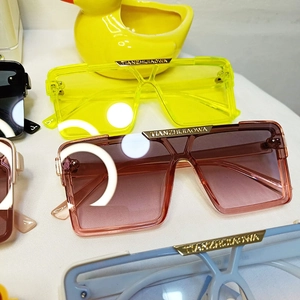 Detail of square children's sunglasses with gold metal bridge and colorful PC frames