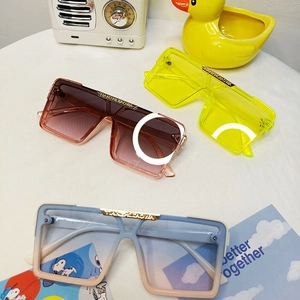 Detailed view of oversized square sunglasses with metal logo and temple specifications