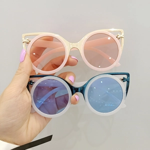 Fashionable round cat eye sunglasses with small bow detail in pink and white frames