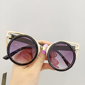 Cat-eye sunglasses with black round frames, golden butterfly metal trim and gradient lenses