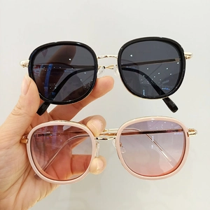 Detail view of stylish kids sunglasses with metal temples in black and pink frames