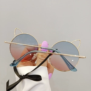 Detailed view of creative cat-ear metal frames with blue and pink gradient lenses