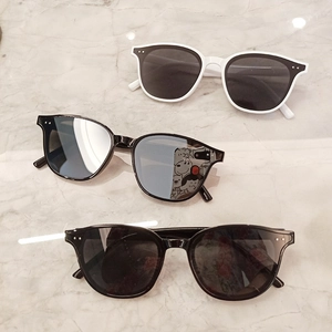 Detailed view of trendy oversized sunglasses featuring signature metal rivet decor on frames