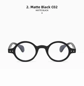 Detail of matte black round optical frames with vintage design and metallic rivets