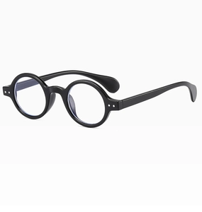 Close-up of retro round black optical frames with polished finish and metal accents
