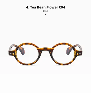 Detail view of round tortoiseshell glasses frames featuring silver decorative rivets