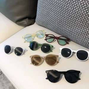 Retro round cartoon sunglasses for kids in seven assorted colors on a white background