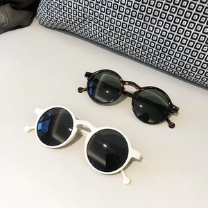 Retro round frame sunglasses in tortoiseshell and white with spherical temple detail