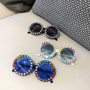 Three pairs of cute rhinestone round sunglasses for kids in black, white, and blue colors