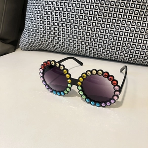 Detail of round children's sunglasses with rainbow rhinestones and gradient lenses