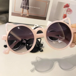 Detailed shot of pink cat-ear children's sunglasses with purple gradient lenses