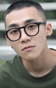 Close-up of classic black Boston frame glasses with silver metal rivets on a male model