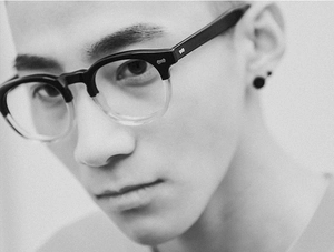 Detail of retro browline glasses with black and transparent frame on a model
