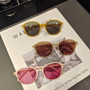 Vertical view of vintage small round sunglasses with assorted colored frames and lenses
