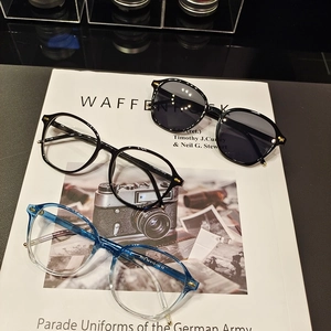Detail view of stylish small frame sunglasses and optical frames with rivet accents