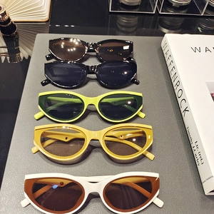 Collection of retro cat-eye sunglasses in multiple colors displayed vertically