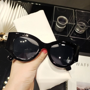 Detail of vintage thick frame sunglasses with inner temple specs and leather pouch