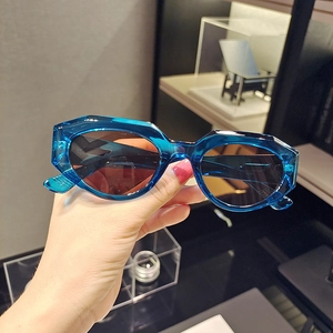 Close-up of translucent blue cat eye sunglasses with thick geometric frame design