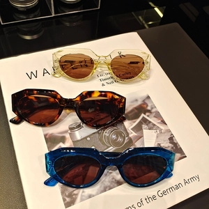 Three pairs of stylish thick-frame cat-eye sunglasses in yellow, tortoiseshell and blue