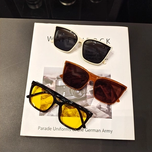Close-up of retro oversized sunglasses in cream, tortoise, and black-yellow frames