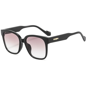 Lunettes de soleil carrées noires oversize avec verres dégradés roses et accents dorés