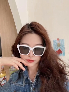 Asian model wearing white square frame sunglasses with dark lenses for retro street style