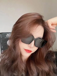 Close-up of black oversized square frame sunglasses worn by model for fashion styling