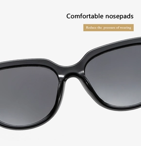 Close-up of ergonomic integrated nose pads on black round frame cat-eye sunglasses