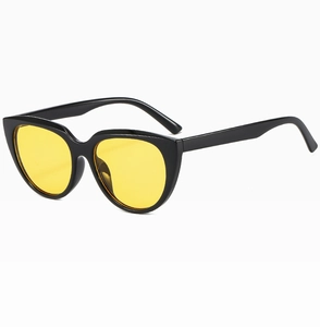 Macro detail of retro cat eye sunglasses with glossy black frames and yellow tinted lenses