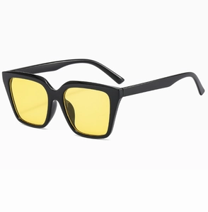 Detail view of bold black square frames with vibrant yellow transparent lenses