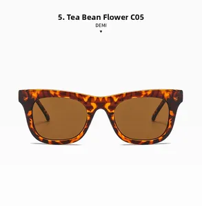 Détail de lunettes de soleil carrées rétro avec monture écaille demi et verres marrons