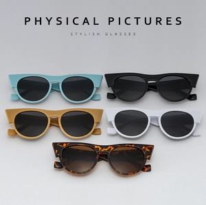 Flat lay of retro cat-eye sunglasses in blue, black, yellow, white, and tortoise patterns