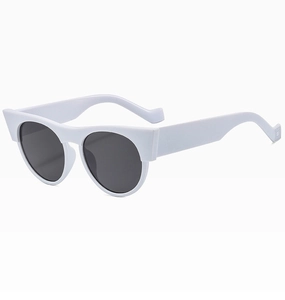 Detail view of white retro cat-eye sunglasses with thick frames and dark lenses