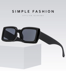Detail of trendy black rectangular sunglasses with thick frames and dark lenses