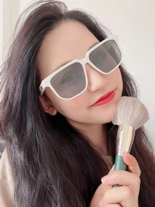 Close-up of retro white square sunglasses with light gray translucent lenses on model