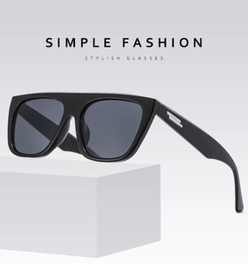 Close-up of flat top square sunglasses with thick temples and silver metal accents