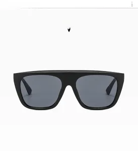 Detail view of flat top black square sunglasses with grey lenses and metal hinge detail