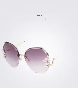 Detail of purple gradient frameless lenses with sparkling rhinestones and floral accents