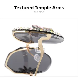Macro detail of gold metal temples and colorful rhinestones on rimless sunglasses