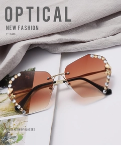 Close-up of rimless gradient brown lenses with crystal accents and small bee metal detail