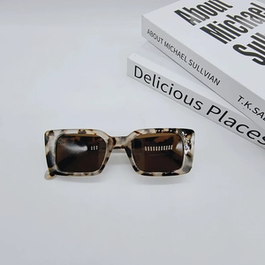 Detail of vintage rectangle sunglasses featuring tortoiseshell texture and dark lenses