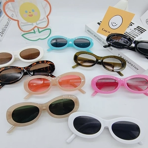 Flat lay of retro oval sunglasses in multiple colors on a clean white background