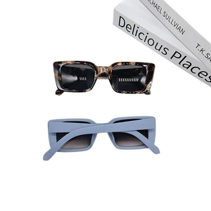 Retro rectangle sunglasses set in tortoiseshell and matte blue on a white background