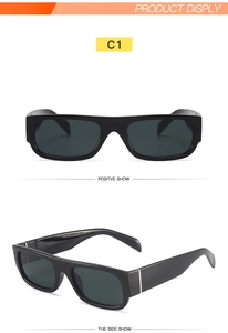 Close-up of rectangular black sunglasses with silver metal accents and dark lenses