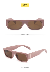 Detail of retro small rectangle sunglasses with smoky pink frames and metal accents