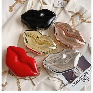 Lip-shaped fashion handbags in five glossy colors shown on a stylish blazer with chains