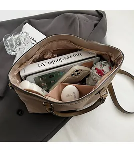 Top view of large khaki tote bag showing interior storage for laptop and books