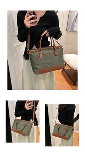 Army green large nylon tote bag with brown leather handles and a removable shoulder strap